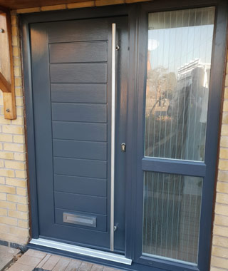 Installation of grey composite door and combination frame.