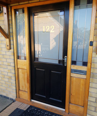 Installation of grey composite door and combination frame.